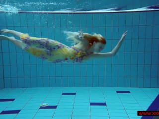 Blonde in a dress in a pool