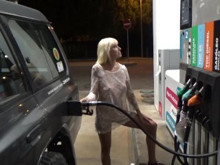 Blonde in a transparent dress fills the car at gas station