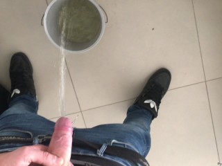 boy peeing in a bucket