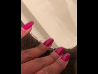 Close up pee in black stripper heels.