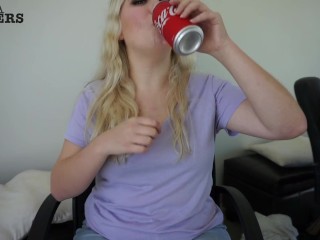 Cute girl drinks soda and burps