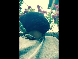 Masked ebony bbw smoking outside in garden and rubbing pussy