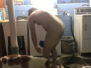 Naked man doing laundry