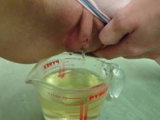 pee in measuring cup  close up