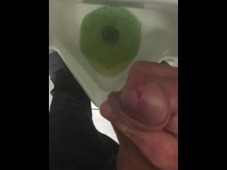 Pissing in a urinal in public at work