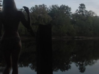 risky public sunset topless striptease over dock on river