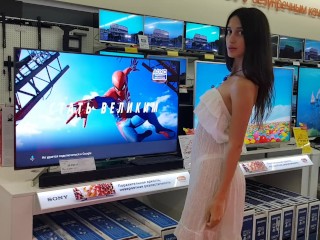 The girl chooses a TV in the store and shows her pussy along the way