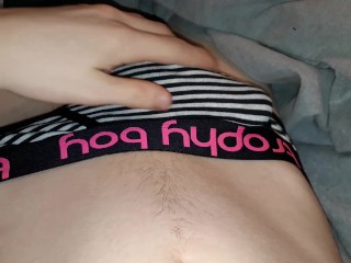 Twink plays with dick through briefs in bed