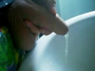Uncut cock gets semi while pissing!